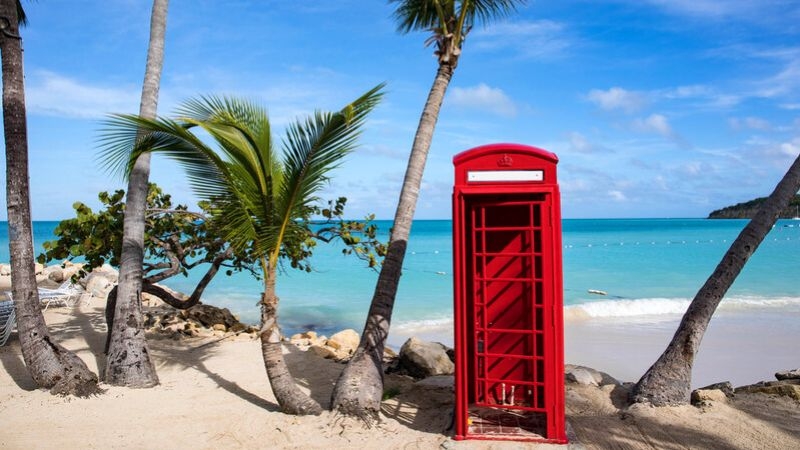 Red postbox on a beach